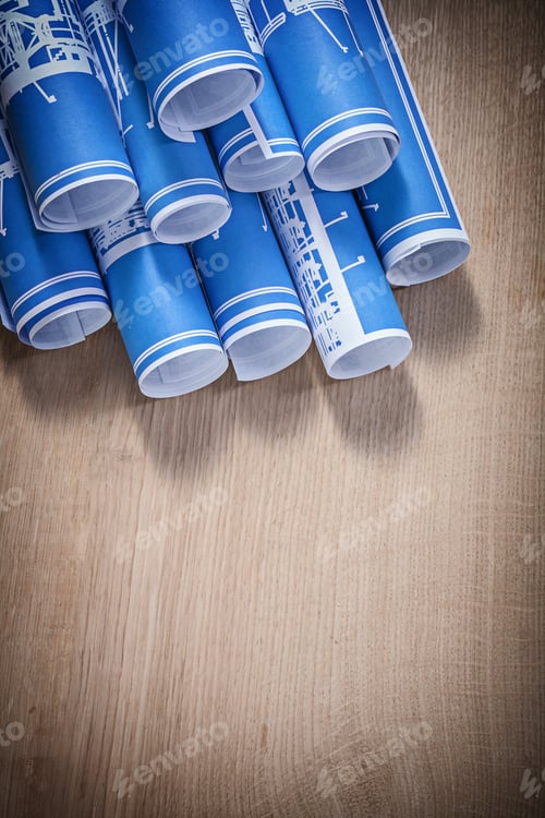 Preview: Blueprints Rolled on a Wooden Surface