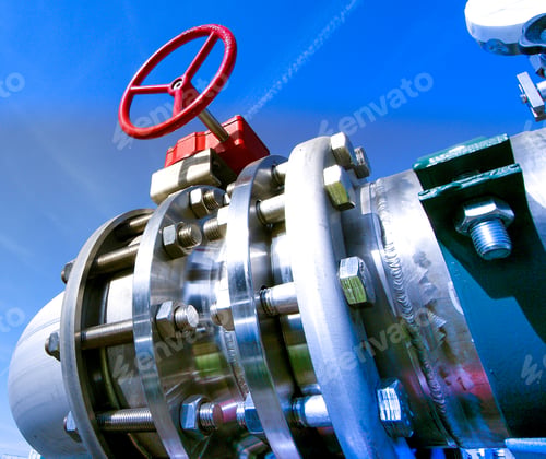 Preview: Industrial Zone, Steel Pipelines And Valves Against Blue Sky