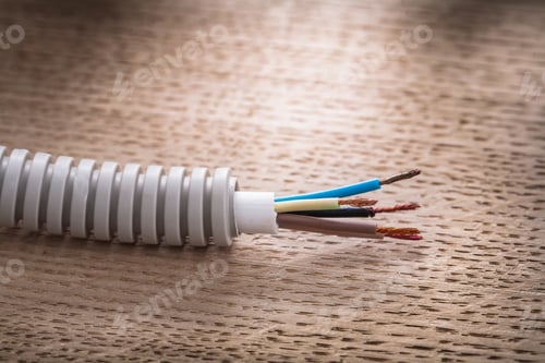 Preview: Electric Corrugated Pipe Cables On Wooden Board Electricity Concept.