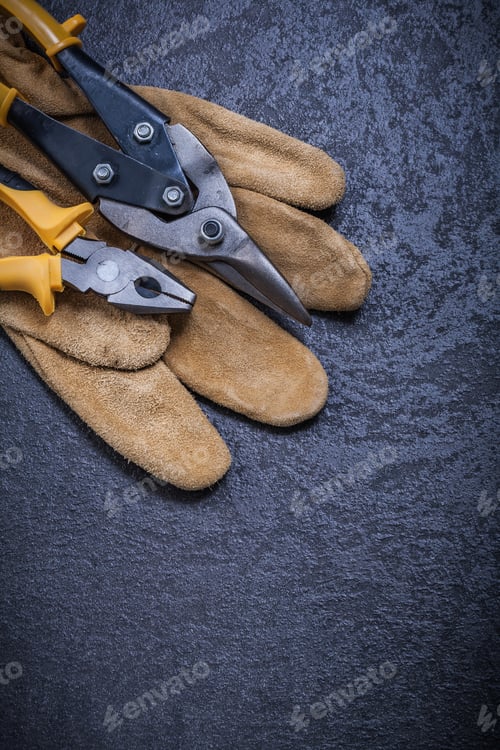 Preview: Steel Cutter Gripping Tongs Leather Protective Glove On Black Background.