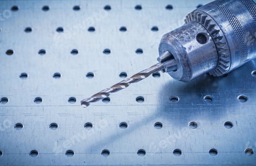 Preview: Metal Drill On Perforated Metallic Background Construction Concept.