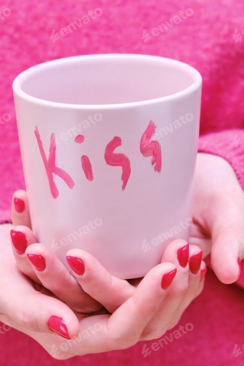 Preview: A Girl In A Pink Sweater With A Romantic Cup. A Woman Holds A Red Mug With The Inscription Kiss.