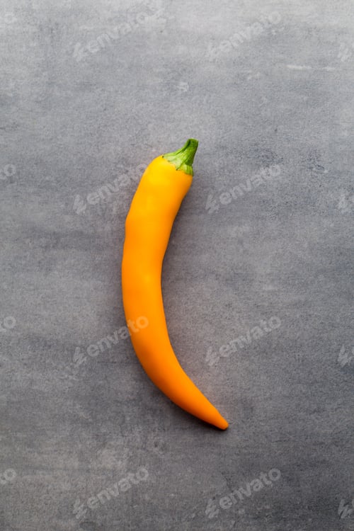 Preview: Chilli Pepper On The Grey Background.