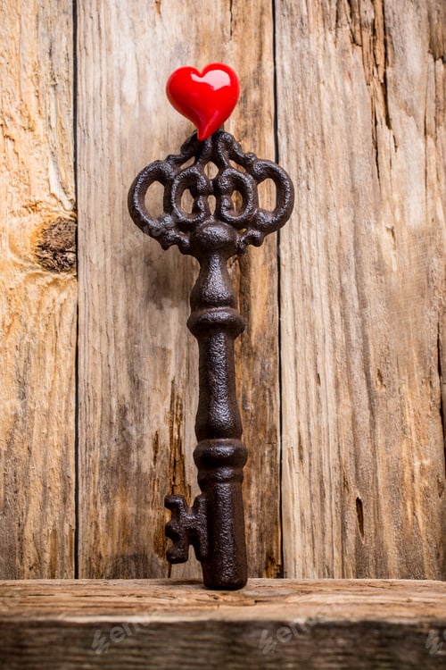 Preview: Old Vintage Key With Heart On Wooden Background.