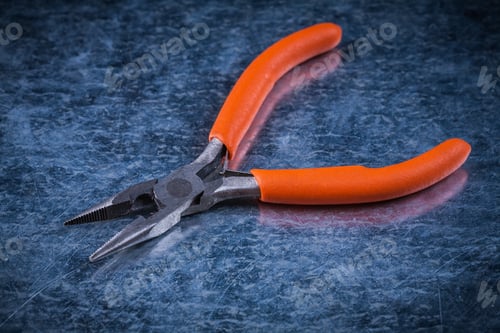 Preview: Insulated Electric Metal Pliers On Metallic Background Electricity Concept.