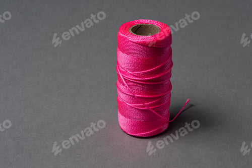 Preview: A Roll Of Pink String On Grey Background.