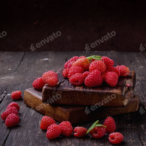 Preview: Fresh Organic Raspberries On Vintage Wooden Boards Over A Rustic Wooden Background. Square Image