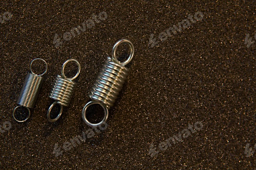 Preview: Flexible Steel Spring On A Dark Background