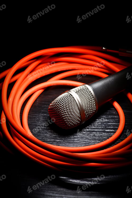 Preview: One Shiny Microphone And A Rolled Up Red Wire