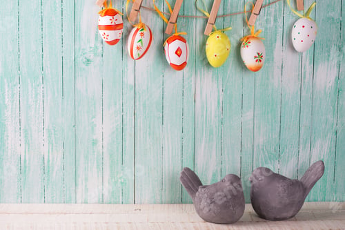 Preview: Two Decorative Birds And Colorful Easter Eggs On Rope On Wooden Background. Easter Background
