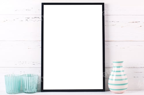 Preview: Black Empty Frame Mockup, Candleholders And Vase With Copy Space Near By Wooden Textured White