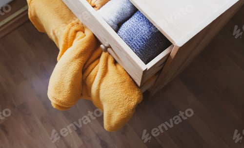 Preview: Open Wooden Dresser Drawer With Warm Knitted Woolen Clothes. Home Vertical Storage. Wardrobe