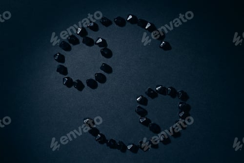 Preview: Symbol Of The Zodiac Sign Cancer Made By Black Stones On A Black Background. Low Dark Key
