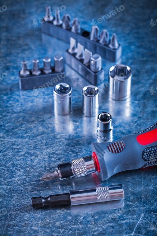 Preview: Composition Of Screwdriver With Replaceable Heads And Bits On Scratched Metallic Surface Vertical