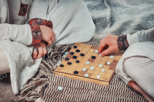 Preview: Hnefatafl - Scandinavian Board Game. A Man And A Woman In National Costumes Playing Similar To