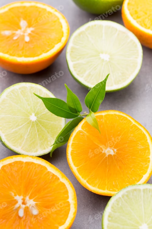 Preview: Mixed Citrus Fruit Lemons, Orange, Kiwi, Limes On A Gray Background.
