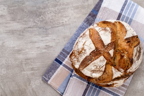 Preview: Freshly Baked Bread On Dark Gray Kitchen Table, Top View.
