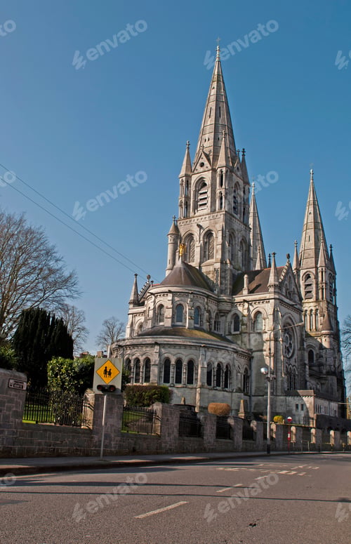 Preview: Saint Fin Barre'S Cathedral In Cork, Ireland (Road View And Blue Sky Background)