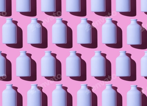 Preview: Colorful Painted Glass Bottles Organized In A Row Over Pink Background