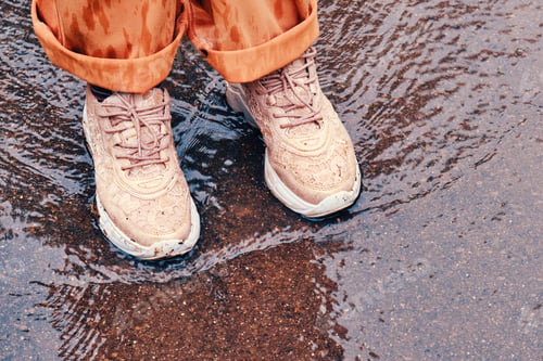 Preview: Children Feet In Orange Shoes Stand In A Spring Stream, Close-Up