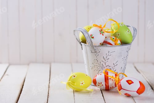 Preview: Colorful Easter Eggs In Bucket On White Wooden Background. Easter Background.