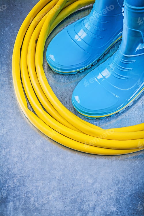 Preview: Safety Rubber Boots Garden Hose On Metallic Background Gardening Concept.