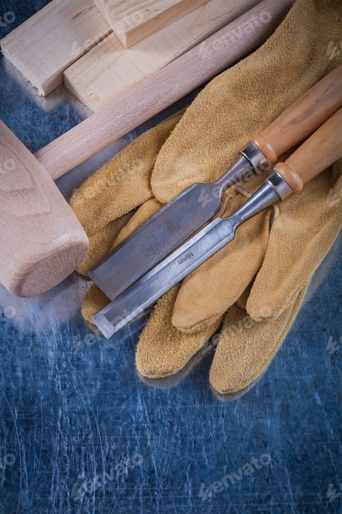 Preview: Wooden Mallet Bricks Flat Chisels And Protective Gloves On Scratched Metallic Surface Construction