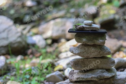 Preview: Phone In A Pyramid Of Stones. Selective Focus. Travel And Hiking Concept