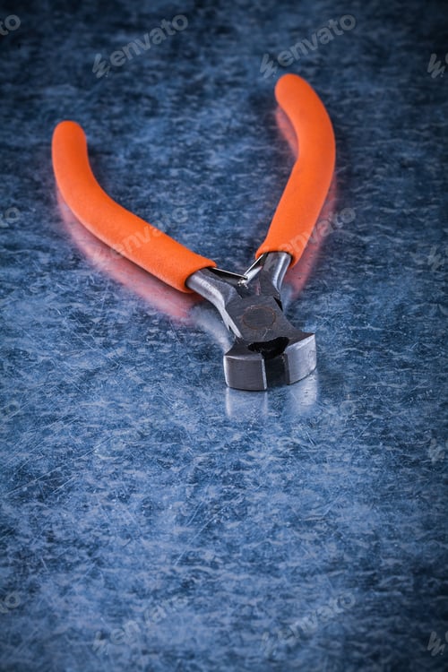 Preview: Insulated Electric Wire Cutter On Metallic Background Electricity Concept.