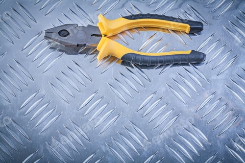 Preview: Gripping Tongs On Grooved Metal Plate Construction Concept.
