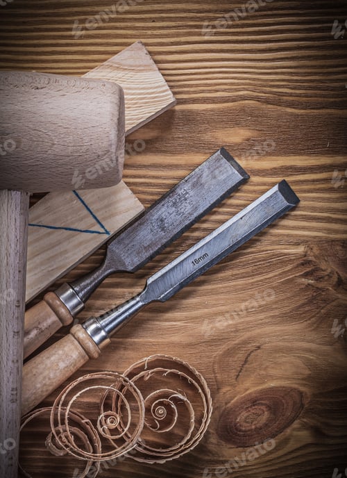Preview: Wooden Hammer Bricks Flat Chisels Curled Shavings On Vintage Wood Board.