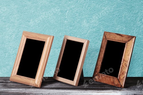 Preview: Wooden Photo Frames On Table, Blue Wall