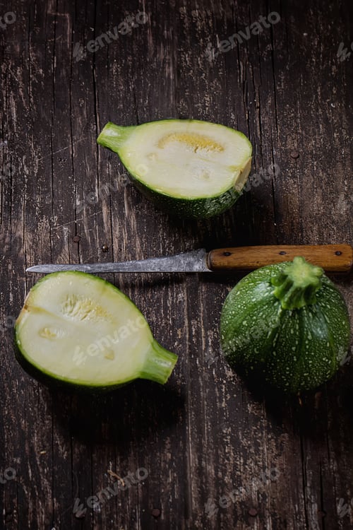 Preview: Mini Zucchinis On Rustic Wooden Board Cut In Halves