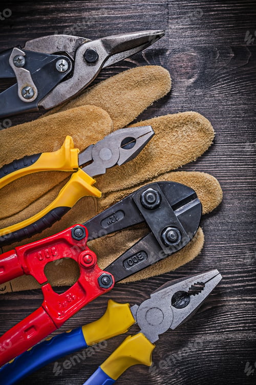 Preview: Leather Protective Glove Steel Wire Cutter Pliers On Wooden Background.