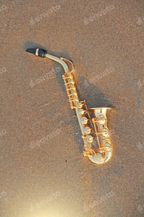 Preview: The Golden Alto Saxophone Lies On The Sand Or On The Beach. Musical Cover And Creative. Design With