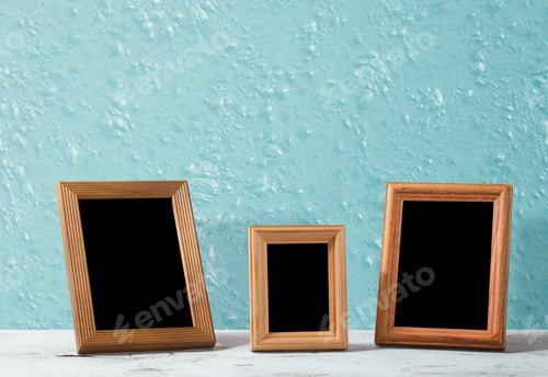 Preview: Wooden Photo Frames On Table, Blue Wall