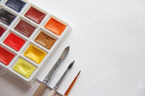 Preview: Palette of Colorful Watercolor Paints with Brushes