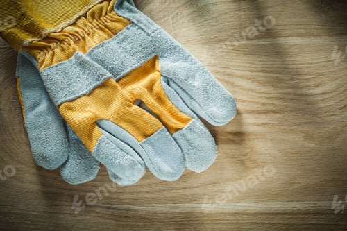 Preview: Pair Of Protective Gloves On Wooden Board.