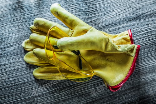 Preview: Set Of Safety Gloves Goggles On Wooden Board.