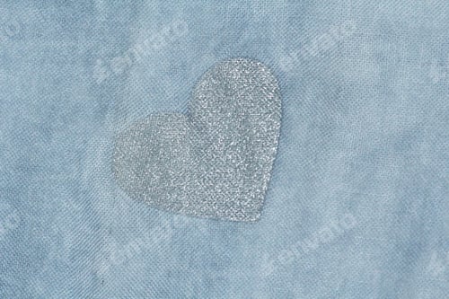 Preview: Silver Heart On A Blue Background Of Cotton Fabric. Romantic Pastel Background. Design With Copy
