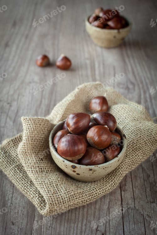 Preview: Bunch Of Fresh Chestnuts In A Bowl On Wooden Table