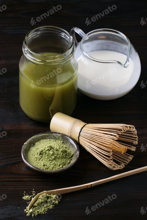 Preview: Green Matcha Tea Served With Cream And Green Matcha Powder With Various Bamboo Accessories For Tea