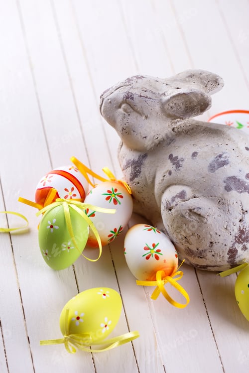 Preview: Colorful Easter Eggs And Rabbit On White Wooden Background. Easter Background.