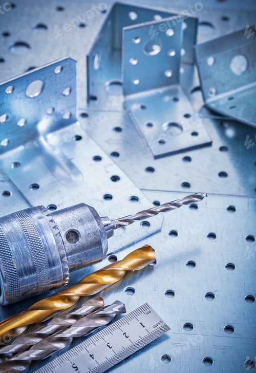 Preview: Metal Ruler Power Drill Bits And Angle Bars On Perforated Metallic Background Construction Concept.
