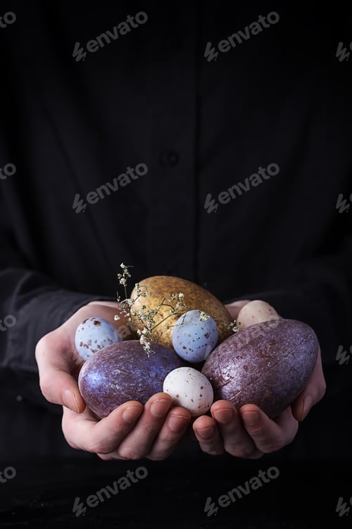 Preview: Male Hands Holding Chocolate Easter Eggs. Rustic Easter Concept. Copy Space