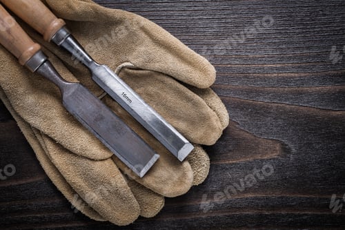 Preview: Pair Of Brown Leather Gloves With Firmer Chisels On Vintage Wooden Board Top View Image
