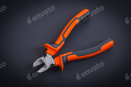 Preview: Opened Nippers With Orange Handles Aerial View On Black Background