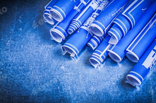 Preview: Blue Rolled Blueprints On Metallic Background Construction Concept.