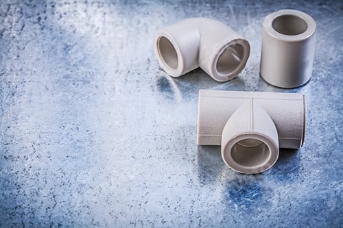 Preview: Plastic Pipe Connectors On Metallic Surface Construction Concept.