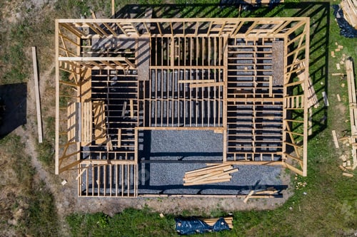 Preview: Frame House Construction. View On New Building With Crane Against Blue Sky